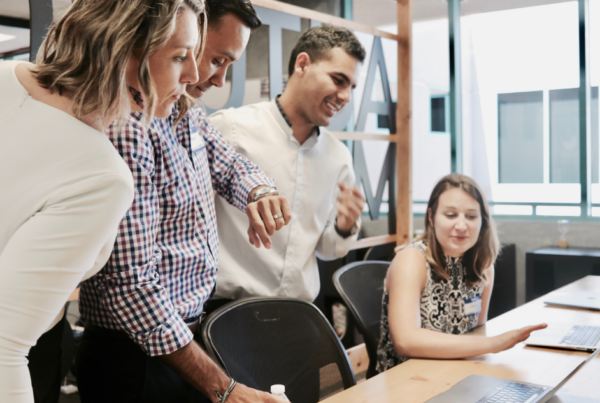 Photo of employees looking at laptop